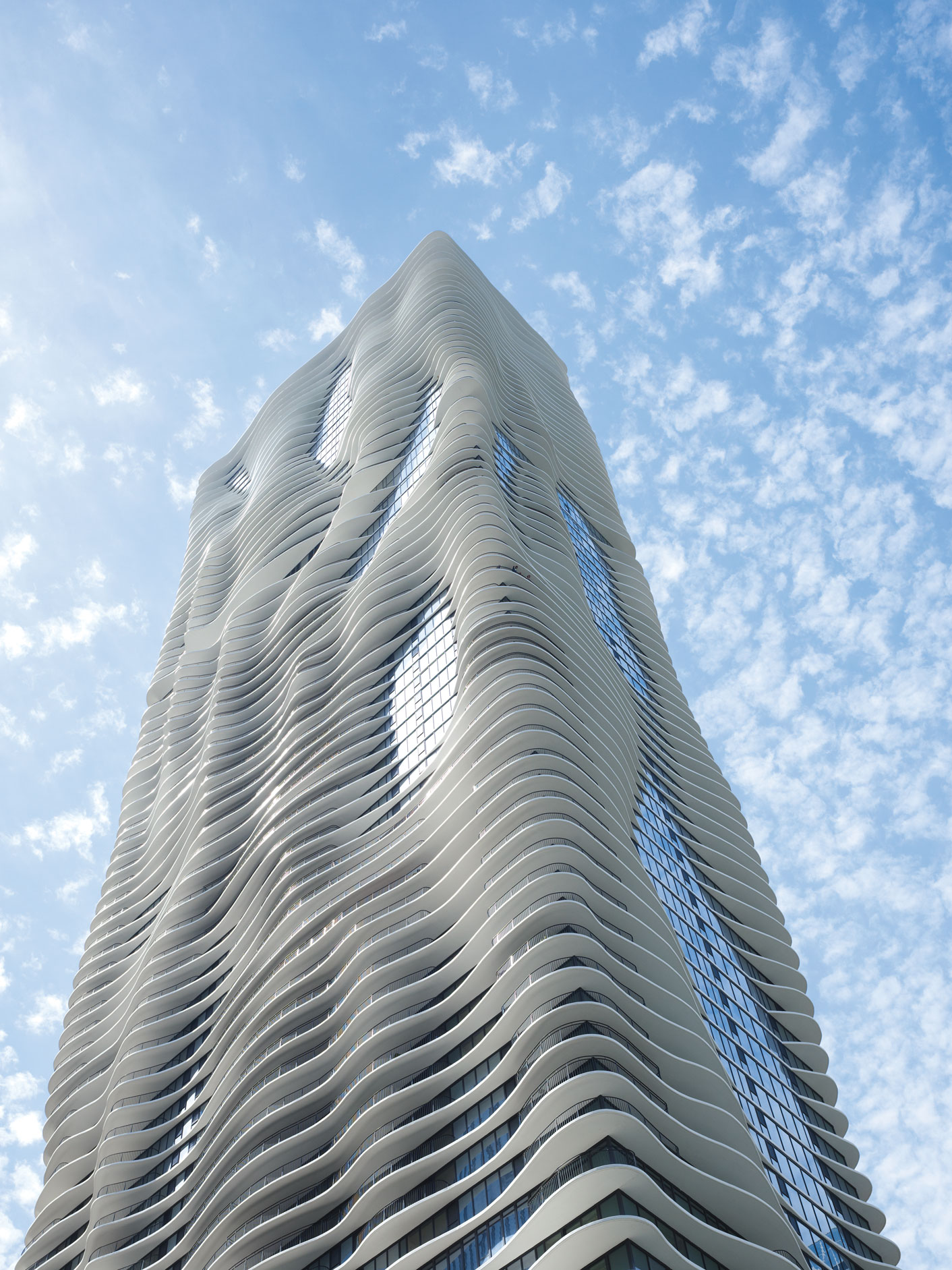 Studio Gang, Aqua Tower, Chicago, Illinois, USA, 2010. 
The Aqua Tower’s floor plates were shaped to give residents sight lines to specific Chicago landmarks as well as to provide solar shading and help break up the wind. The cantilevered, curvilinear slabs produce an elevation with variegated light and shadow as well as the appearance of undulating movement when seen from below. Steve Hall © Hall + Merrick