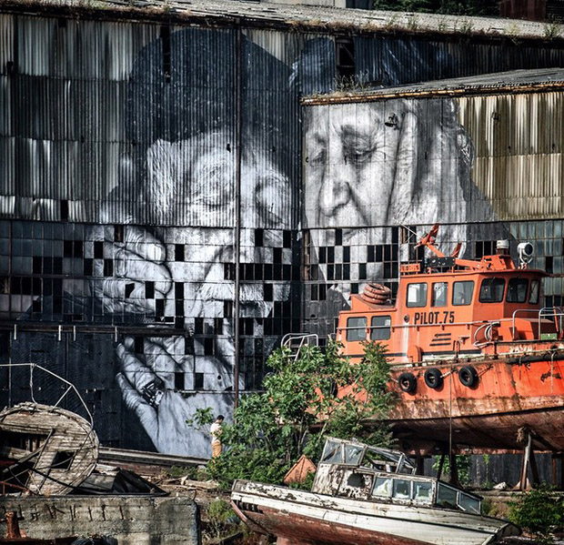 JR's portrait of Ali, an old fisherman from Istanbul, and his wife Sukran on the Old Docks, as part of the artist's latest iteration of The Wrinkles of the City.