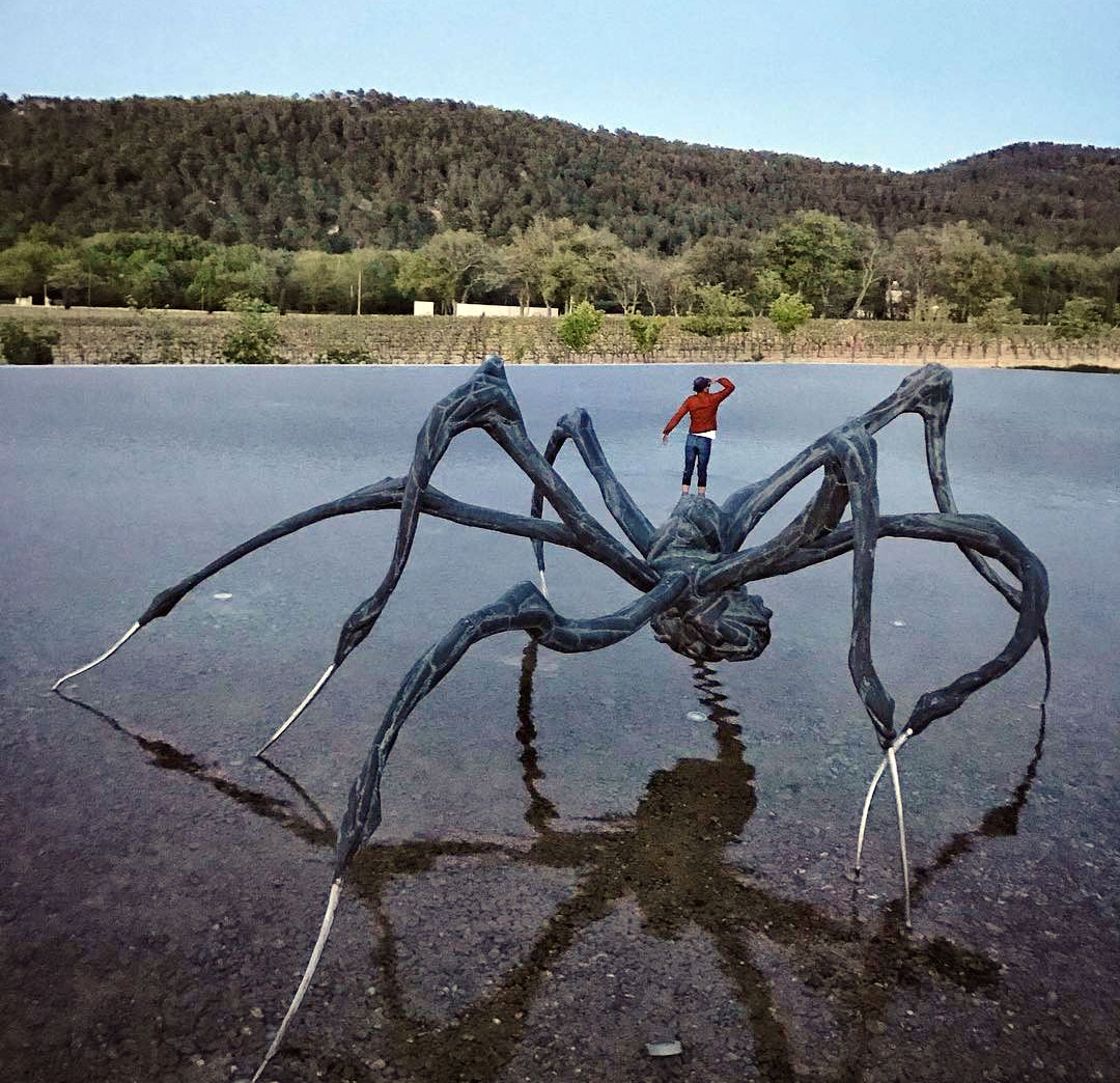 JR on top of Crouching Spider (2003) by Louise Bourgeois. Photograph by Diego Osorio. Image courtesy of JR's Instagram