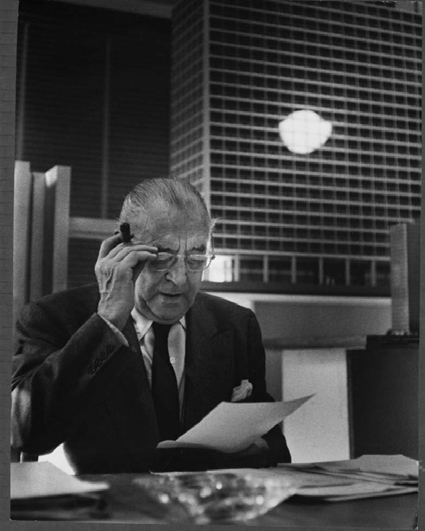 Mies with a model of new IBM building in background, ca. 1969–71